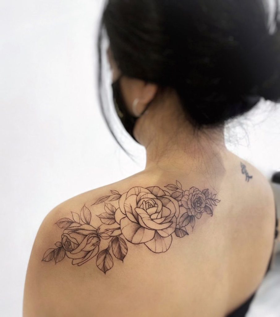 Sketchy rose tattoos on the left shoulder